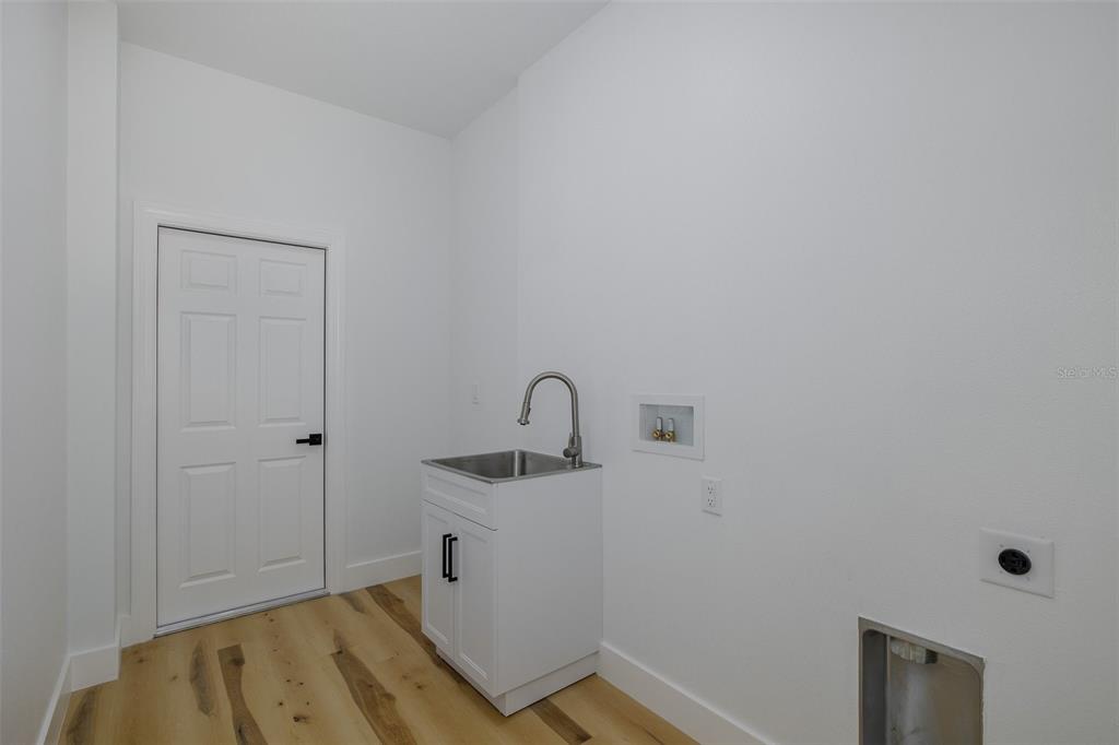 11277 Fool Duck Avenue Weeki Wachee, FL 34613 - Photo 22 of 75 a room with a sink and a mirror