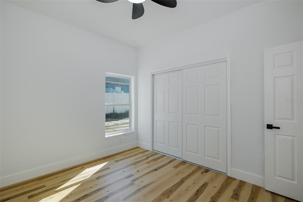 11277 Fool Duck Avenue Weeki Wachee, FL 34613 - Photo 47 of 75 a view of an empty room with wooden floor and a window