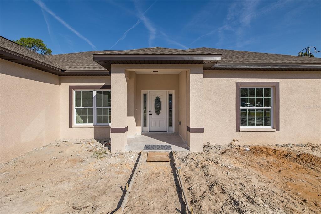11277 Fool Duck Avenue Weeki Wachee, FL 34613 - Photo 57 of 75 a front view of a house with a yard