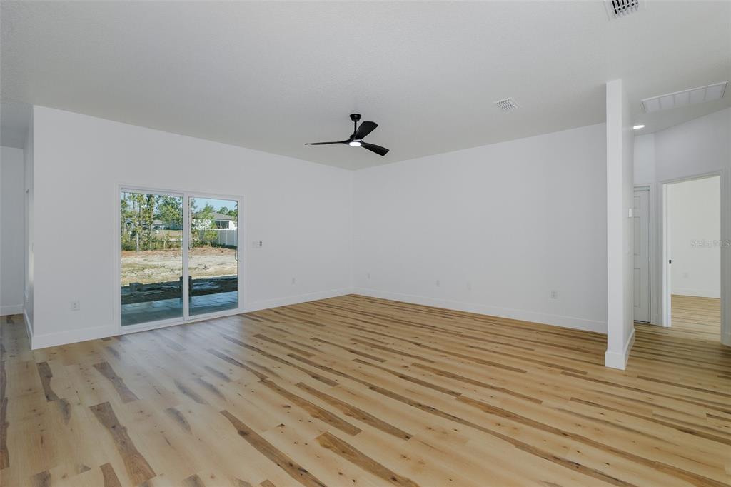11277 Fool Duck Avenue Weeki Wachee, FL 34613 - Photo 66 of 75 wooden floor in an empty room with a window