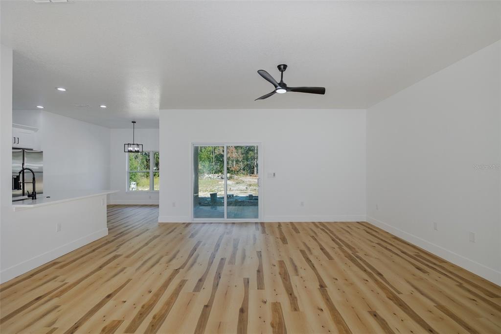 11277 Fool Duck Avenue Weeki Wachee, FL 34613 - Photo 67 of 75 a view of empty room with wooden floor and window