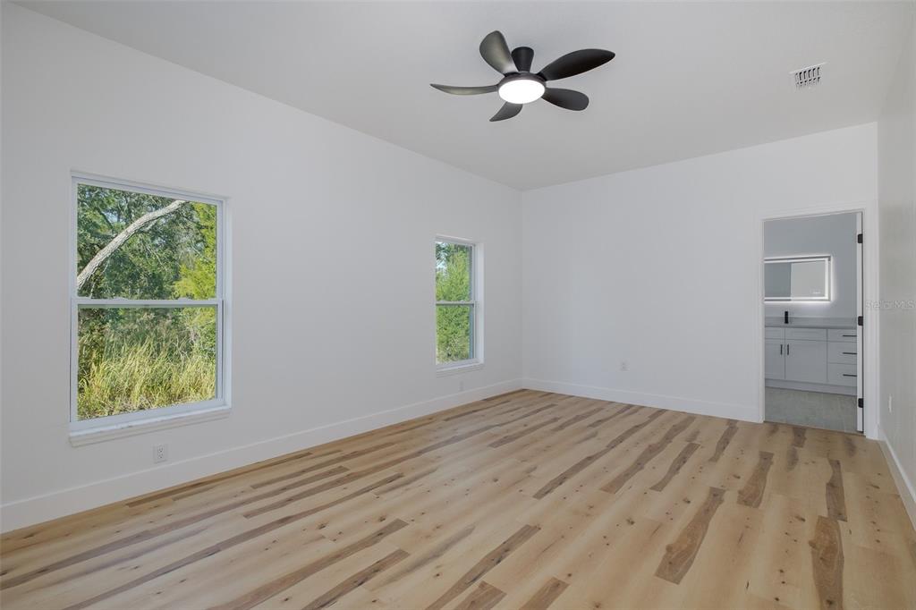 11277 Fool Duck Avenue Weeki Wachee, FL 34613 - Photo 73 of 75 a view of empty room with wooden floor and fan