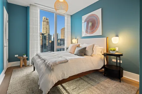 a bed sitting in a bedroom next to a window