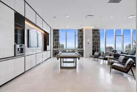 a living room with furniture and large windows