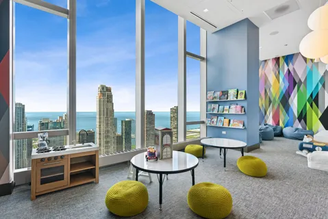 a living room with furniture and large windows