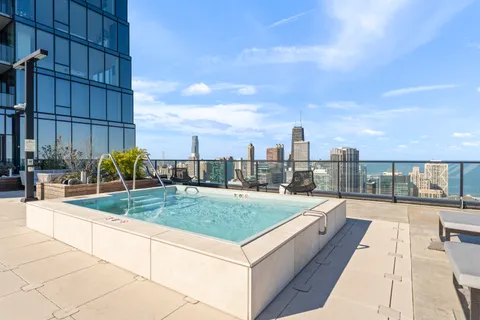 a view of a swimming pool and an outdoor seating