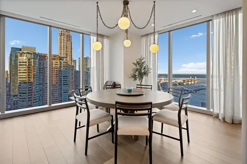a dining room with furniture and window