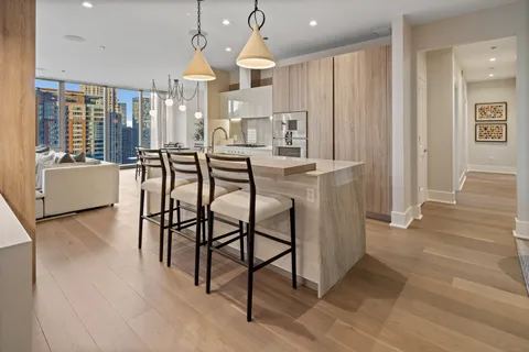 a kitchen with stainless steel appliances granite countertop a sink a stove and a refrigerator