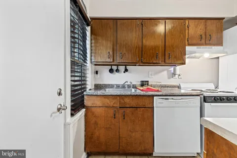a kitchen with a sink a cabinets and appliances