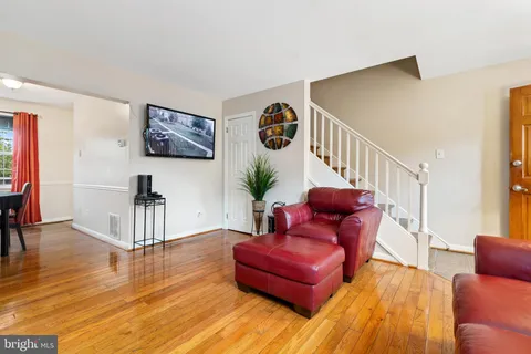 a living room with furniture or wooden floor and a potted plant