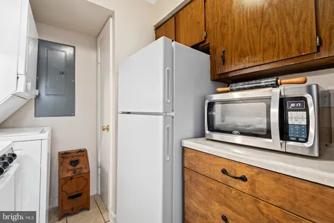 a white refrigerator freezer and a wooden cabinets