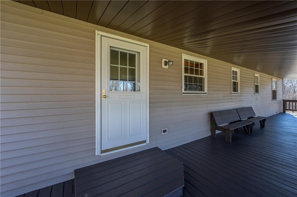 599 Laurel Summit Road Boswell, PA 15531 - Photo 14 of 35 a view of a deck with table and chairs with wooden floor and stairs