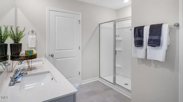 a bathroom with a sink a mirror and shower