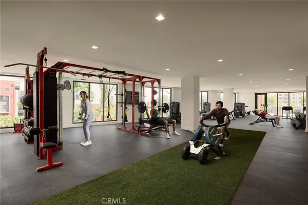 a living room with furniture and large windows