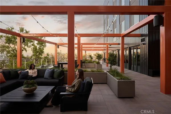 a room with lots of tables a large mirror and furniture