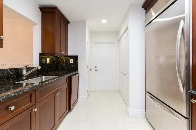 a kitchen with stainless steel appliances granite countertop a sink and cabinets