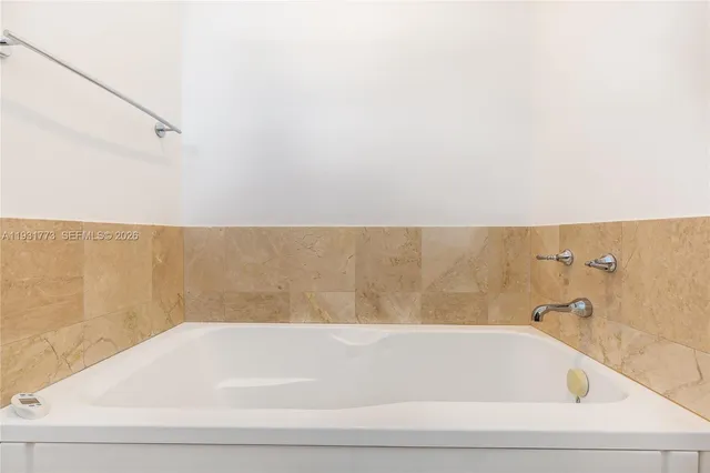 a bathroom with a granite countertop sink toilet a large mirror and shower
