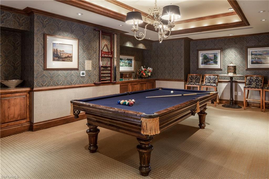 7117 Pelican Bay Boulevard, Unit 206 Naples, FL 34108 - Photo 22 of 35 a pool table sitting in the middle of a room