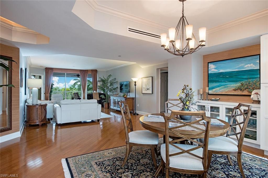 7117 Pelican Bay Boulevard, Unit 206 Naples, FL 34108 - Photo 3 of 35 a view of a livingroom and dining room