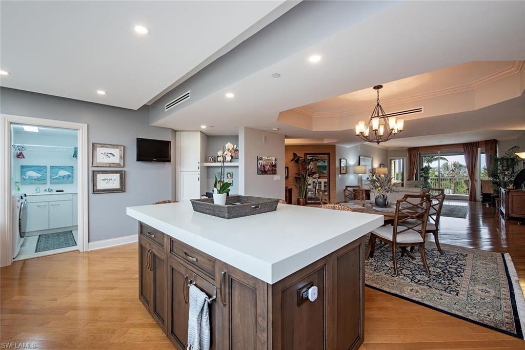 7117 Pelican Bay Boulevard, Unit 206 Naples, FL 34108 - Photo 4 of 35 a view of kitchen island with breakfast area