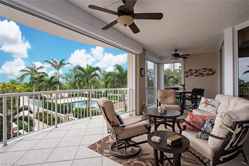 7117 Pelican Bay Boulevard, Unit 206 Naples, FL 34108 - Photo 8 of 35 a balcony with furniture and a potted plant