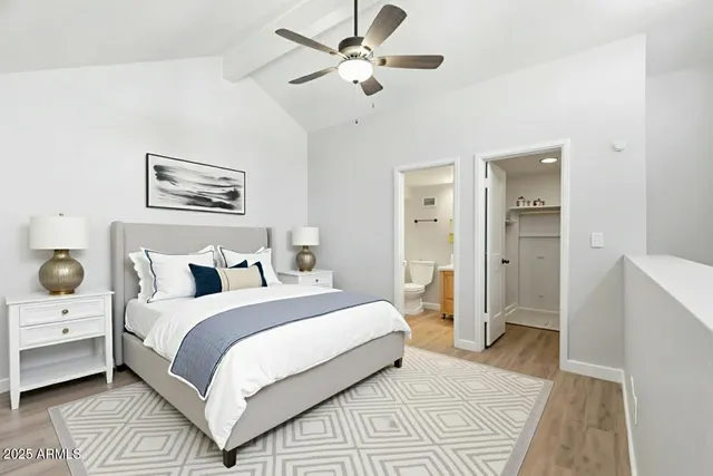 a bedroom with bed and a chandelier