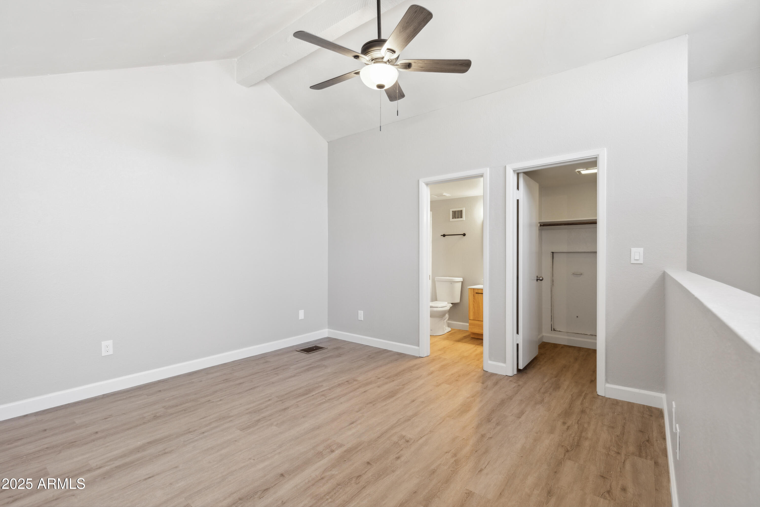 30 East Brown Road, Unit 2081 Mesa, AZ 85201 - Photo 11 of 19 an empty room with wooden floor and a ceiling fan