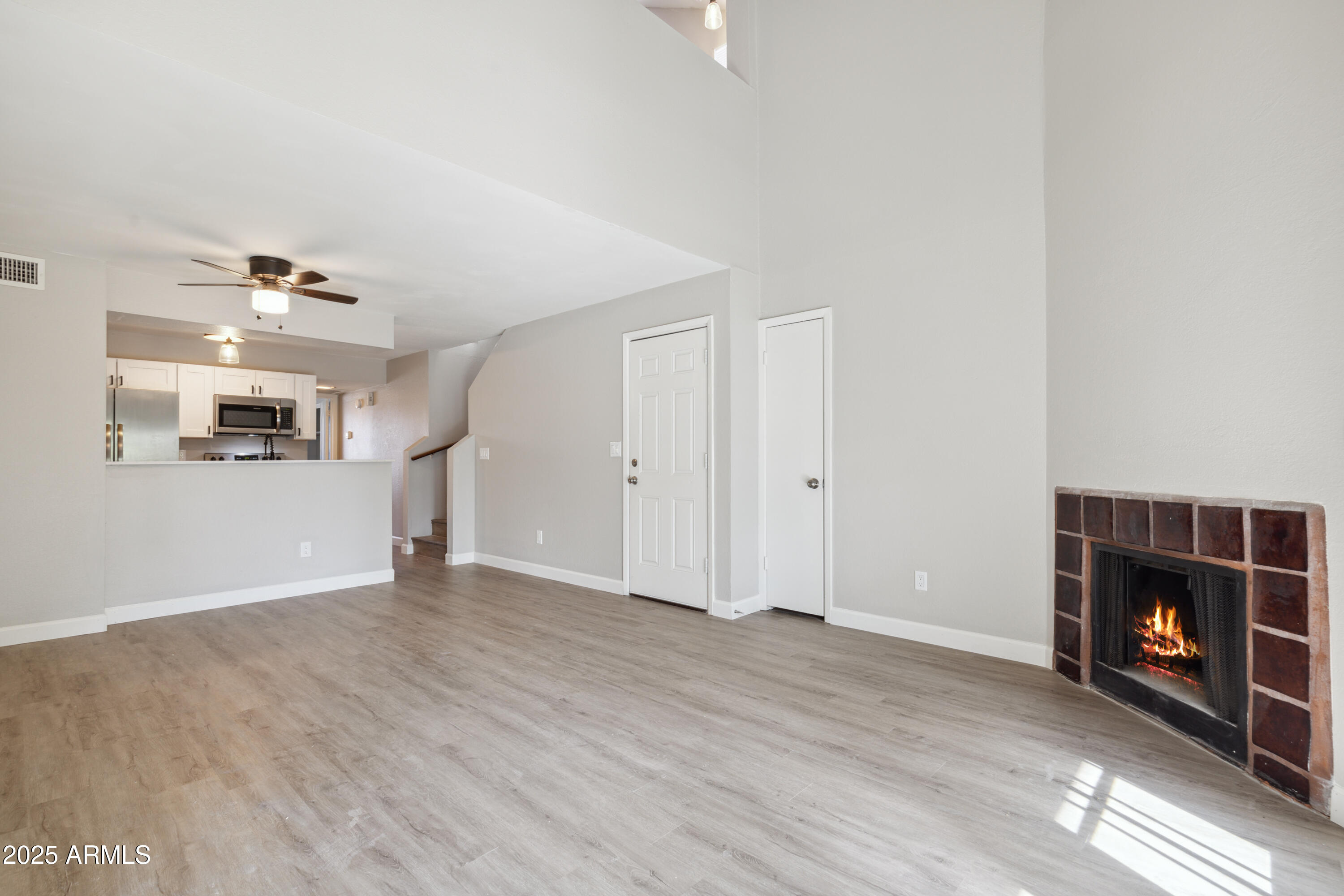 30 East Brown Road, Unit 2081 Mesa, AZ 85201 - Photo 2 of 19 a view of a livingroom with wooden floor and a fireplace