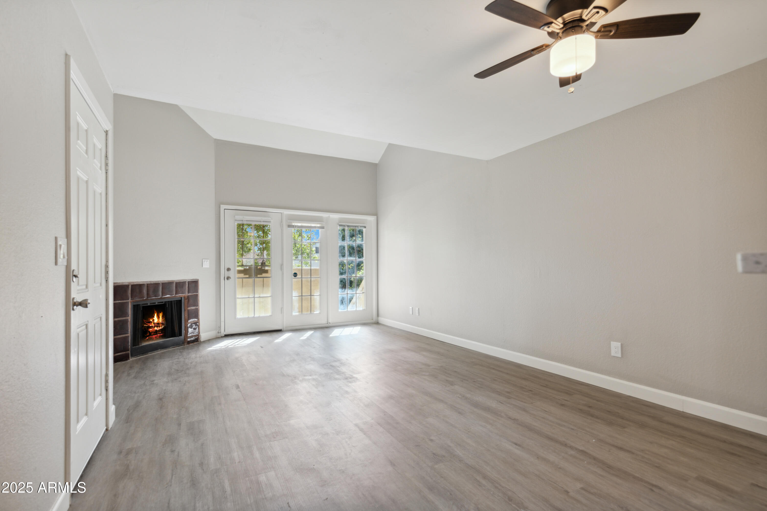 30 East Brown Road, Unit 2081 Mesa, AZ 85201 - Photo 3 of 19 a view of an empty room with a fireplace and a window