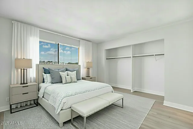 a bedroom with a bed and a window