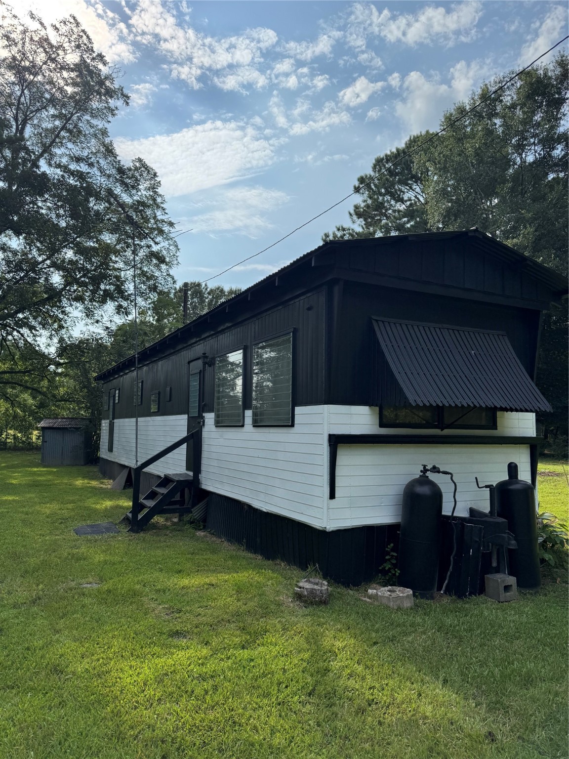 a view of a chair and table in backyard
