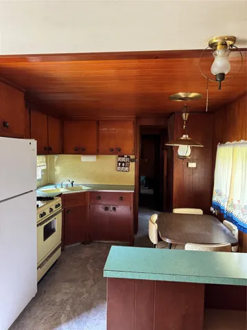 a kitchen with stainless steel appliances granite countertop a sink dishwasher stove and refrigerator