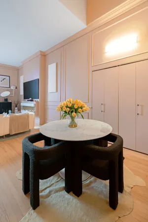 a dining room with furniture a flat screen tv and a chandelier