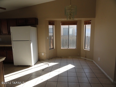 5730 North Ezybrook Road Tucson, AZ 85741 - Photo 4 of 10 a view of a hallway with wooden floor and a refrigerator