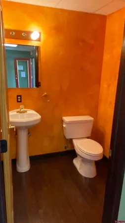 a white toilet sitting next to a bathroom sink