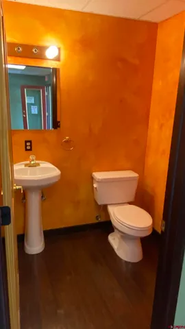 a white toilet sitting next to a bathroom sink