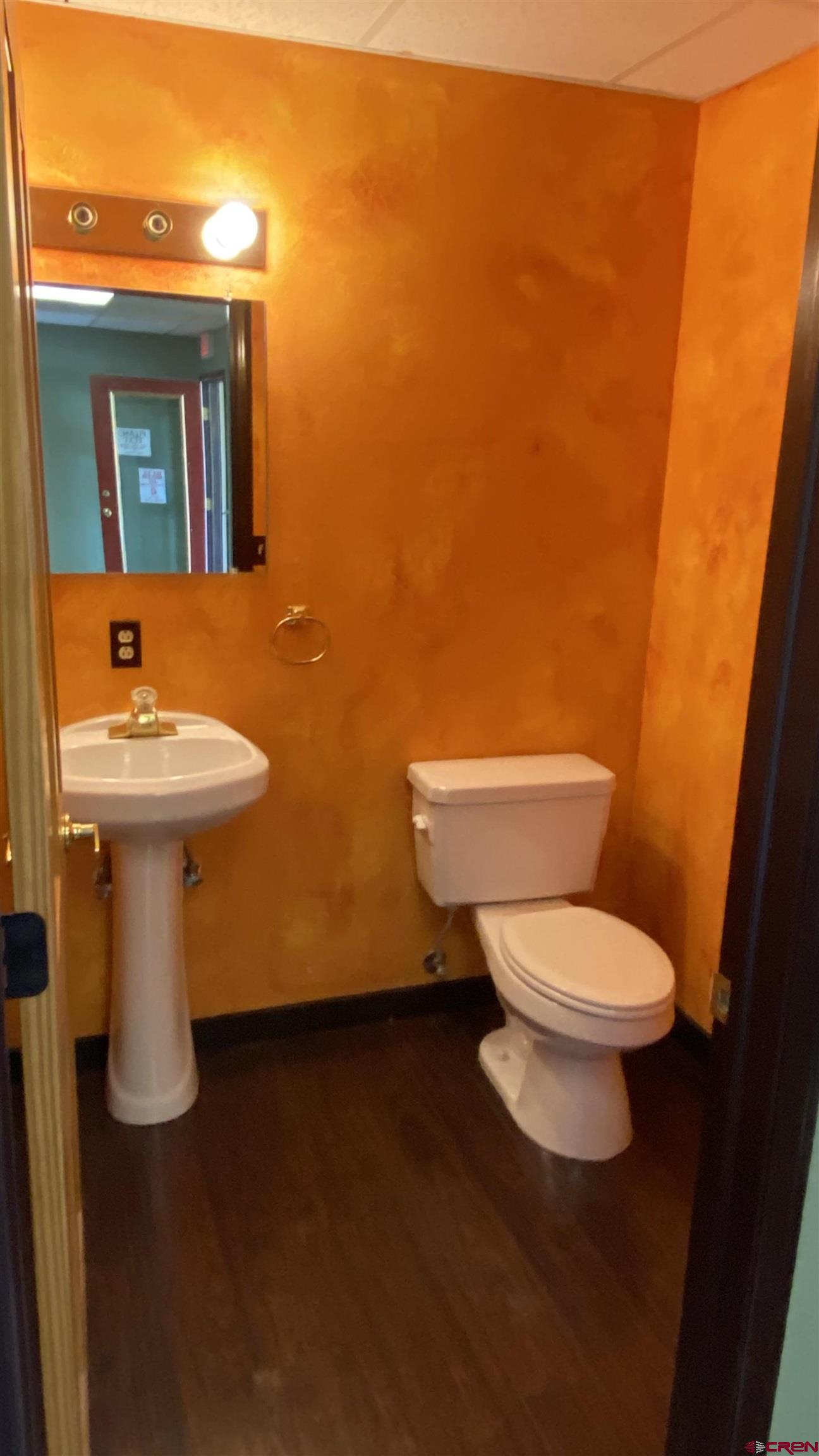 146 Sawyer Drive, Unit C Durango, CO 81303 - Photo 4 of 8 a white toilet sitting next to a bathroom sink