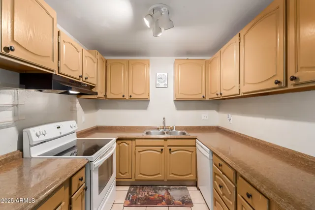a kitchen with a sink cabinets and window