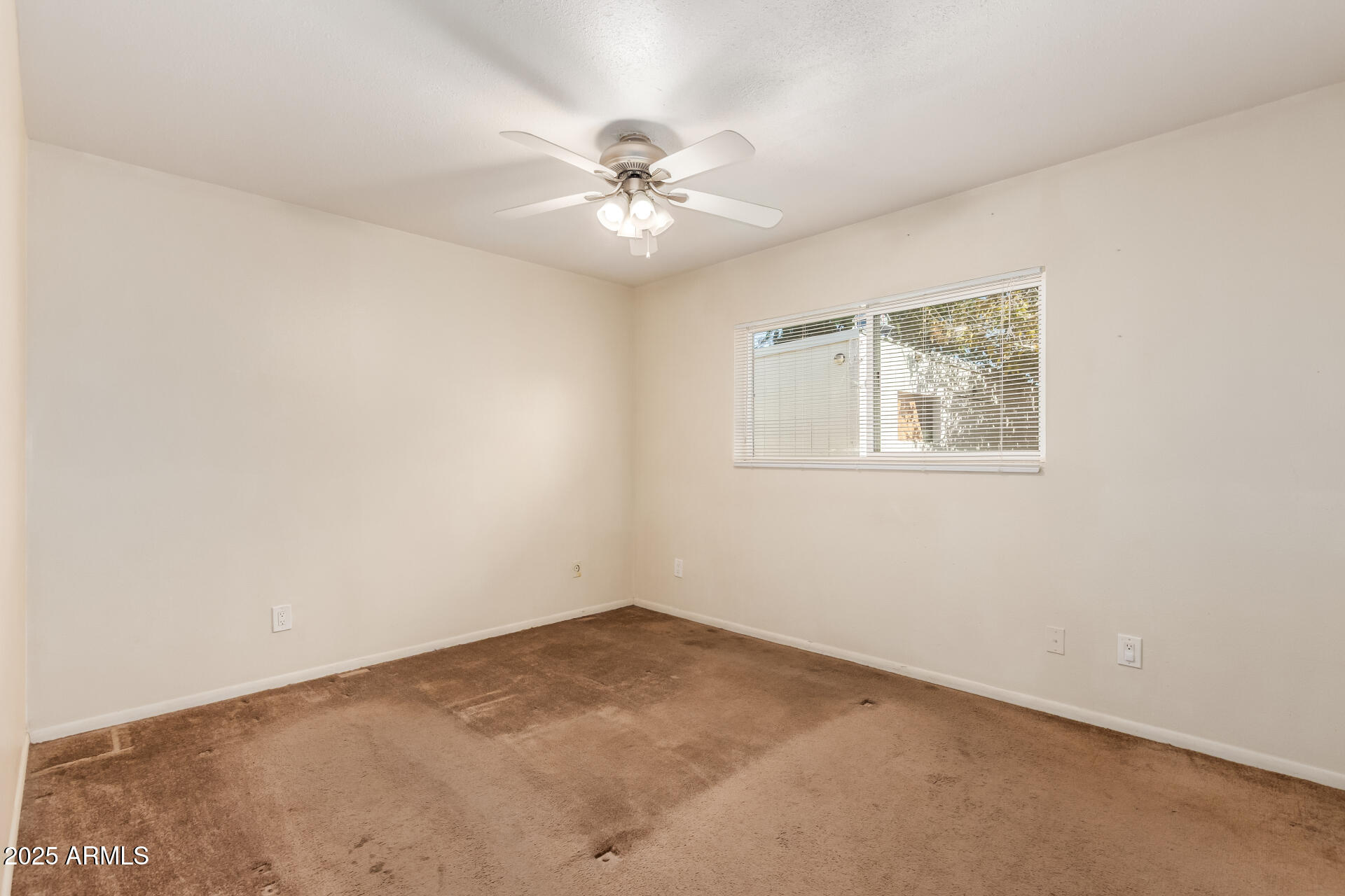 3251 West Cortez Avenue Phoenix, AZ 85029 - Photo 18 of 32 an empty room with a window and a fan
