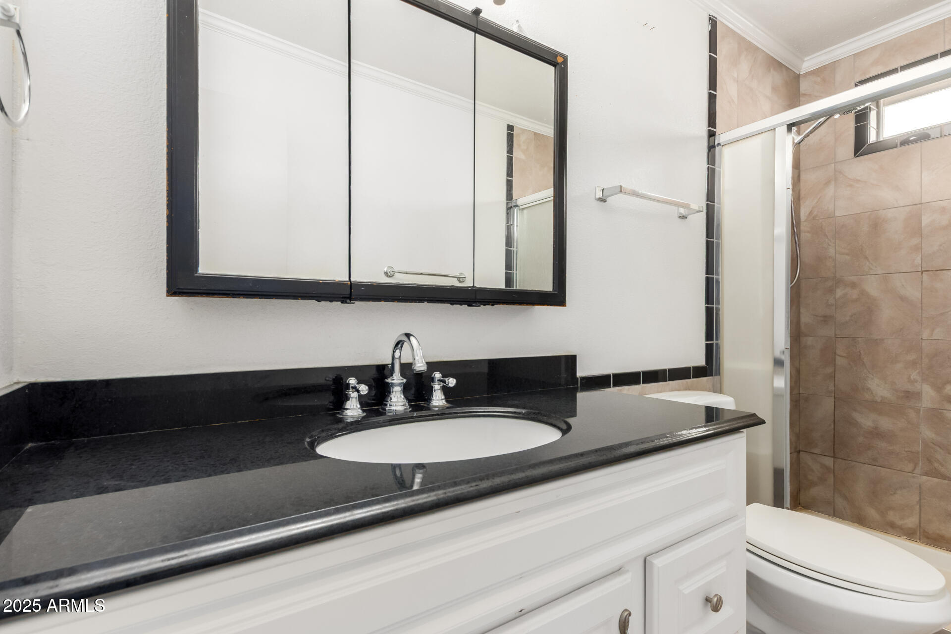 3251 West Cortez Avenue Phoenix, AZ 85029 - Photo 22 of 32 a bathroom with a granite countertop sink a mirror a vanity and a shower