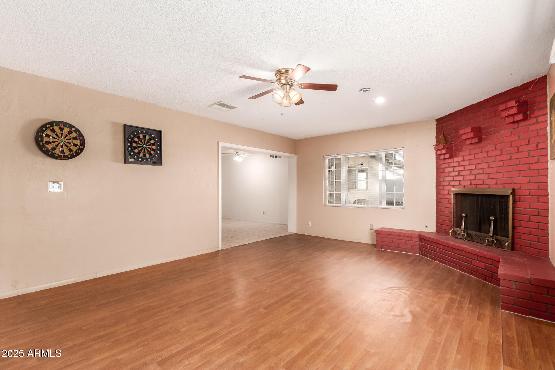 3251 West Cortez Avenue Phoenix, AZ 85029 - Photo 9 of 32 an empty room with windows and fireplace