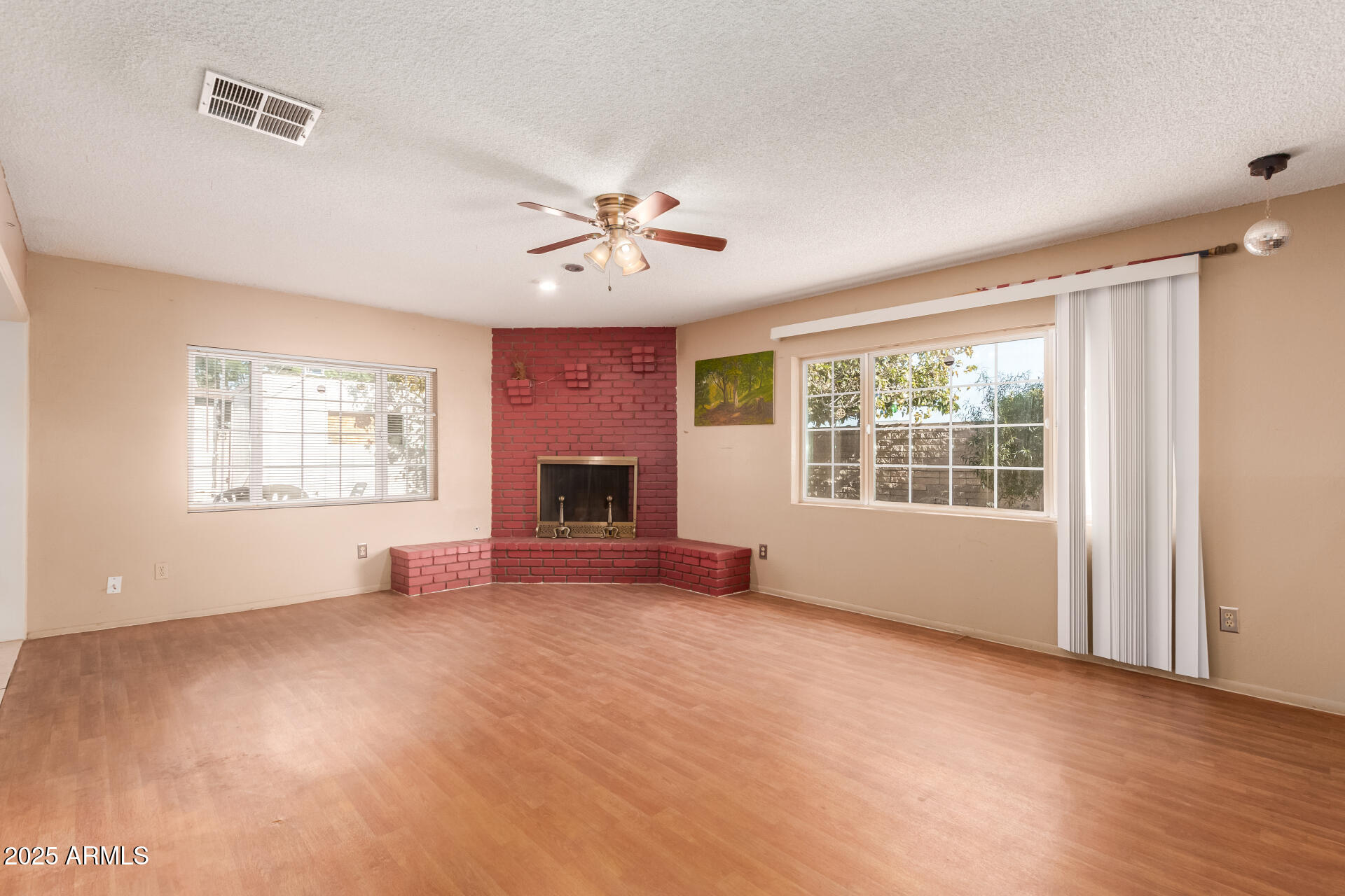 3251 West Cortez Avenue Phoenix, AZ 85029 - Photo 10 of 32 a view of an empty room with a window and a kitchen