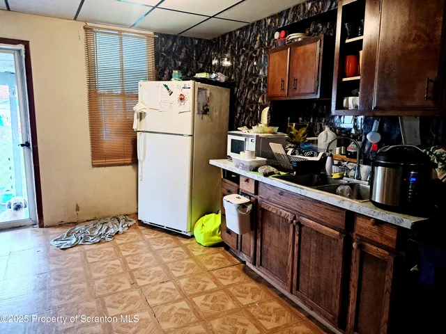 a bathroom with a sink and mirror with bathtub