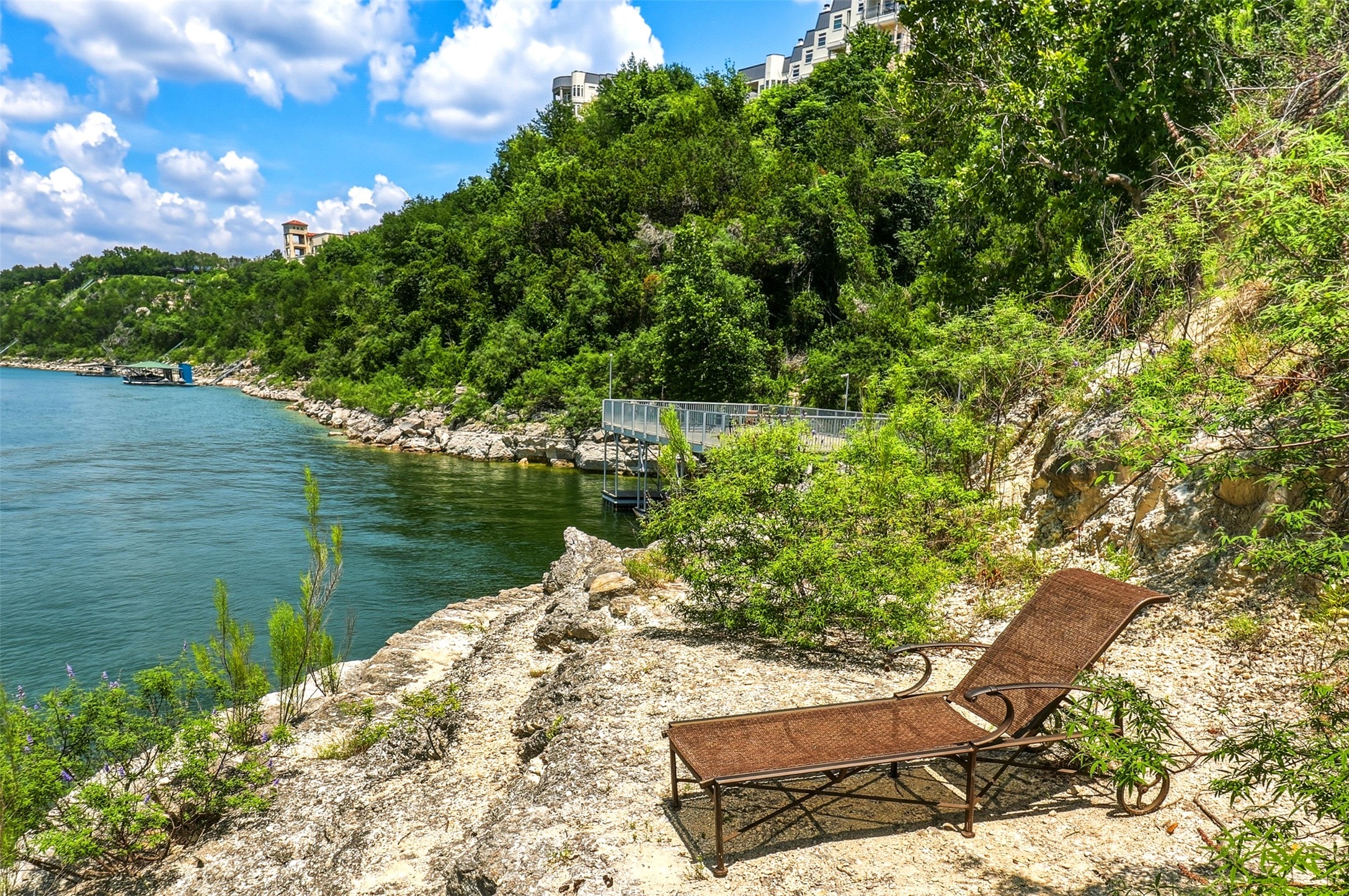 2918 Ranch Road 620, Unit 265 Austin, TX 78734 - Photo 34 of 40 A tranquil waterside retreat, offering a dock for aquatic adventures and serene natural surroundings.