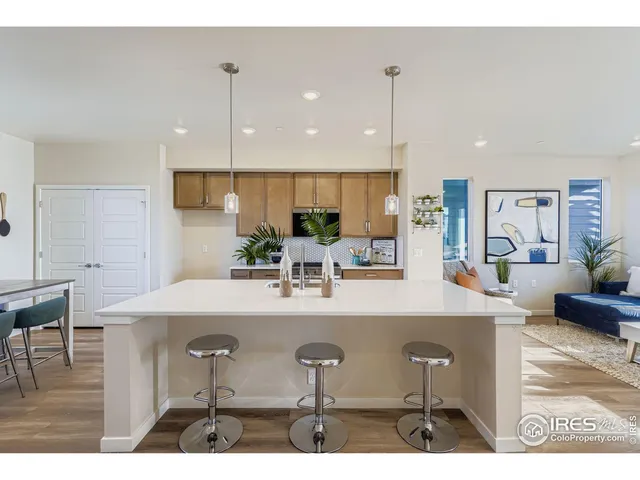 a view of a kitchen with kitchen island and stainless steel appliances