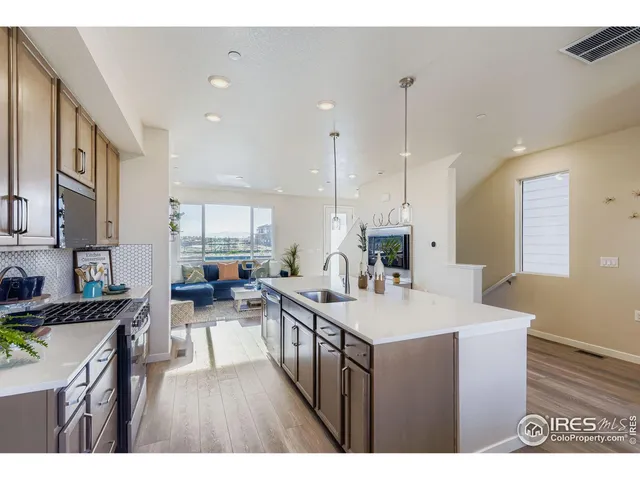 a kitchen with counter top space a sink stove and cabinets