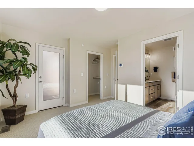 a bedroom with a bed and a potted plant