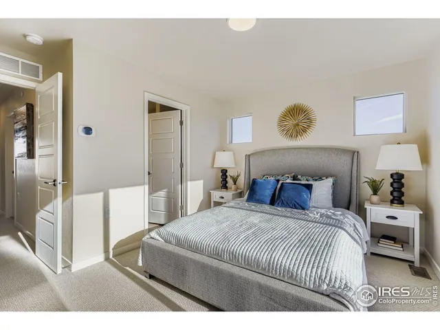 a bedroom with a bed and a painting on the wall