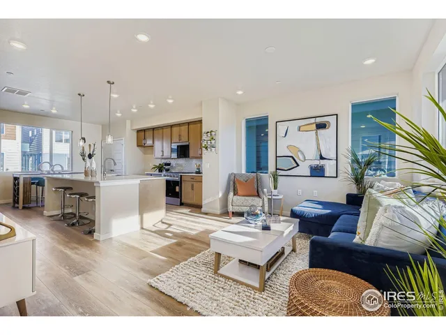a living room with furniture and kitchen view