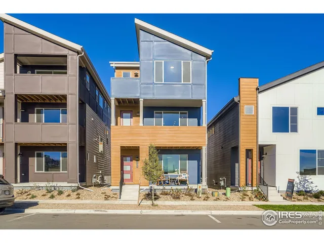 a front view of a building with white apartments